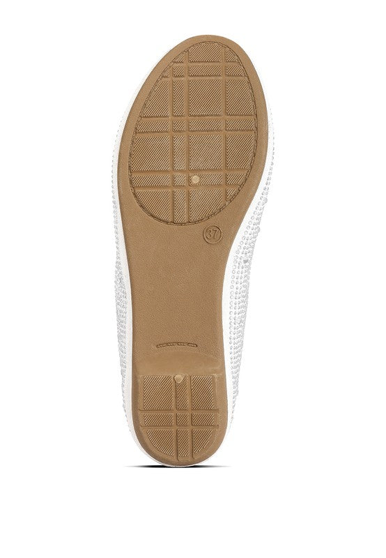 Bottom view of off-white ballet flats with textured outsole and rhinestone trim