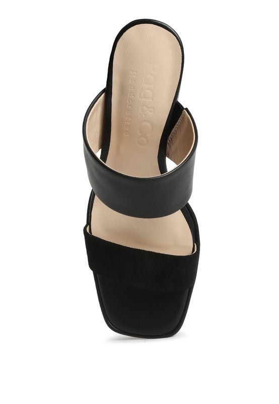 Black slide sandal from side angle with thick platform sole and heel