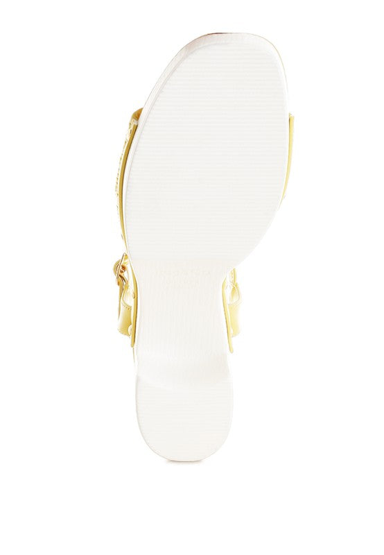 Yellow platform sandal sole view, block heel and toe strap hardware