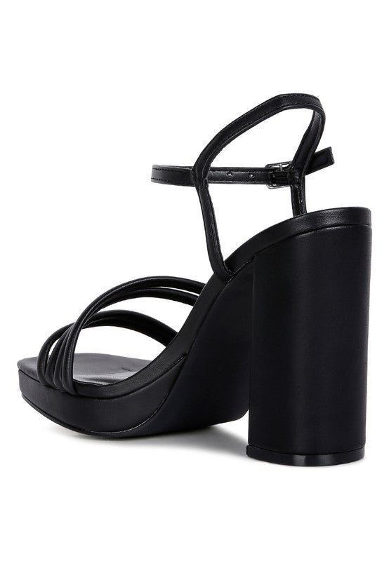Black platform high-heel sandals with curved ankle strap and block heel