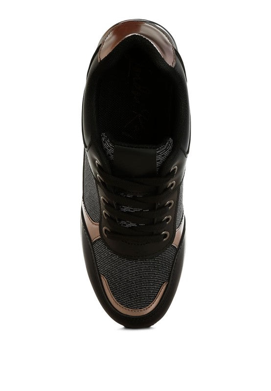 Black sneakers with tan-brown toe and heel panels, black laces