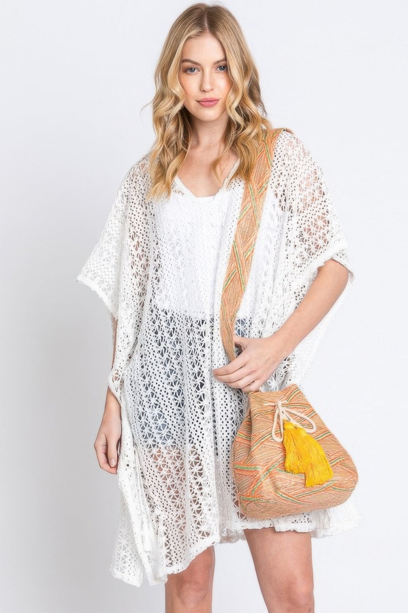 Aztec bucket bag with coral/terracotta body, yellow tassel, Aztec strap