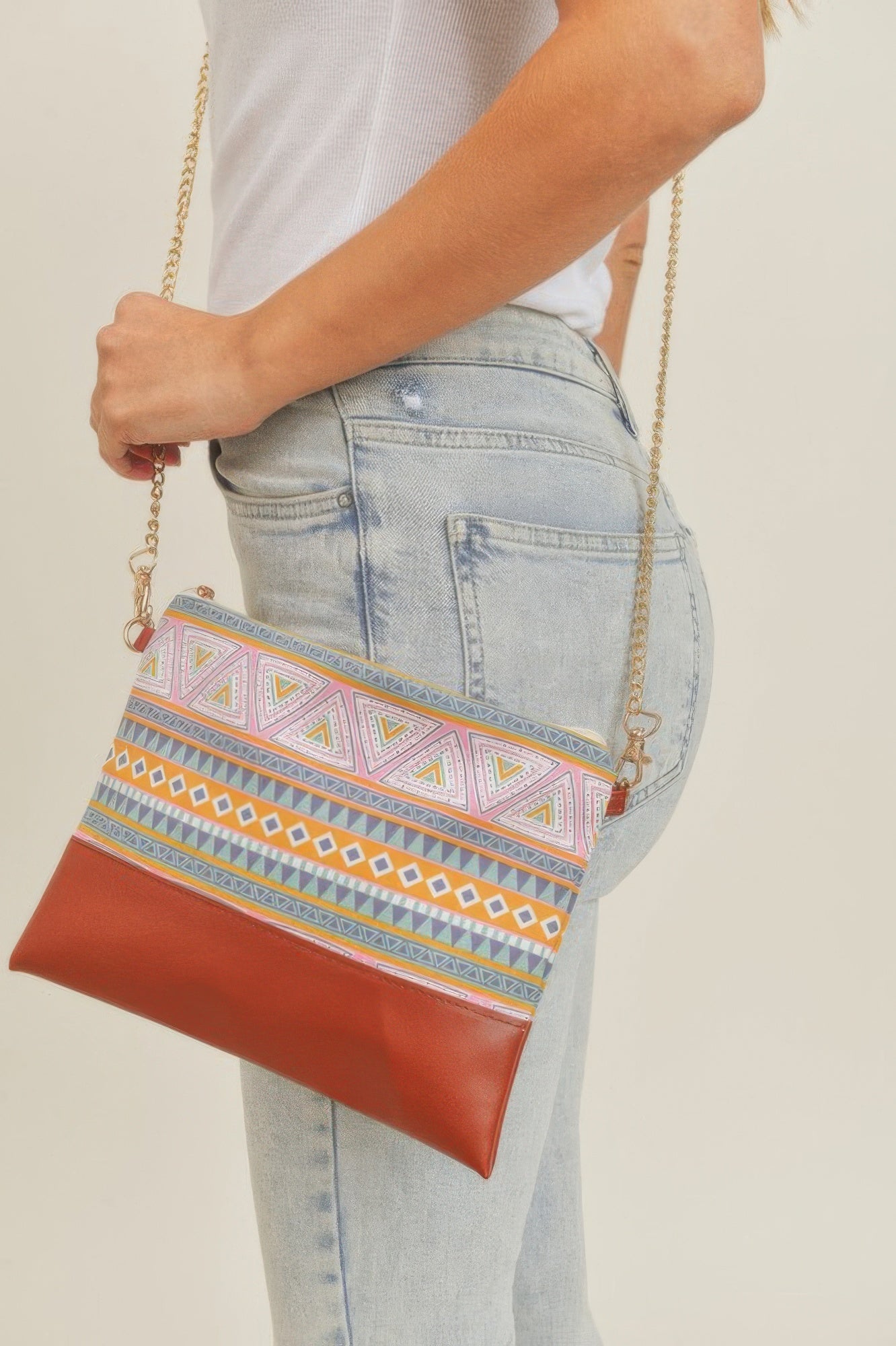Aztec crossbody bag with gold chain strap, multicolor top panel and brown leather bottom