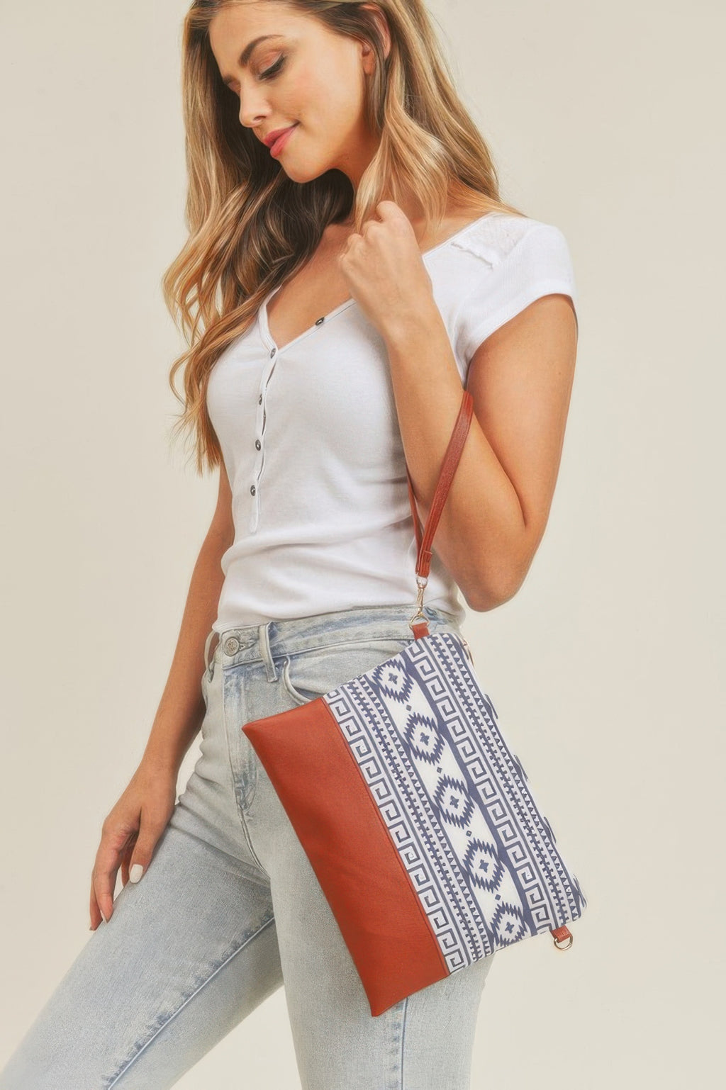 Aztec crossbody with blue-and-white woven-style print and brown faux-leather flap