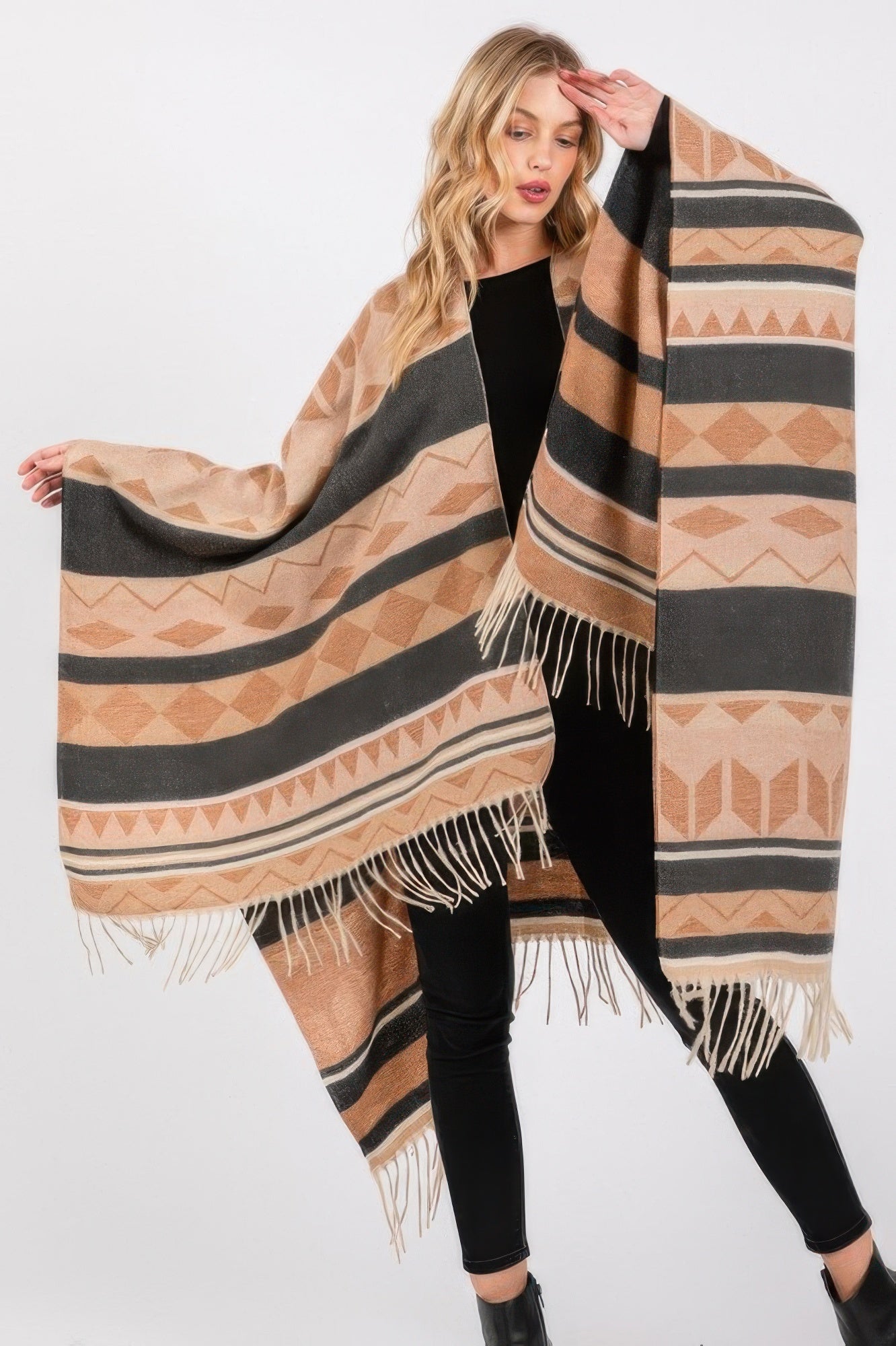 Aztec-pattern ruana in tan, black, and gray with long fringe trim