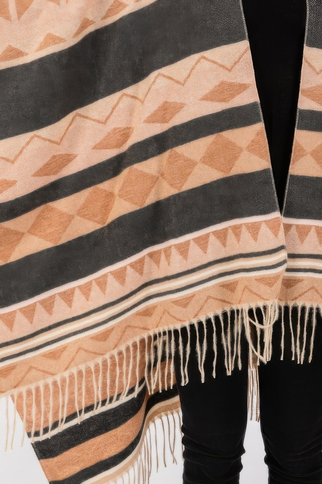 Aztec ruana fabric close-up: geometric stripes with cream fringe edge