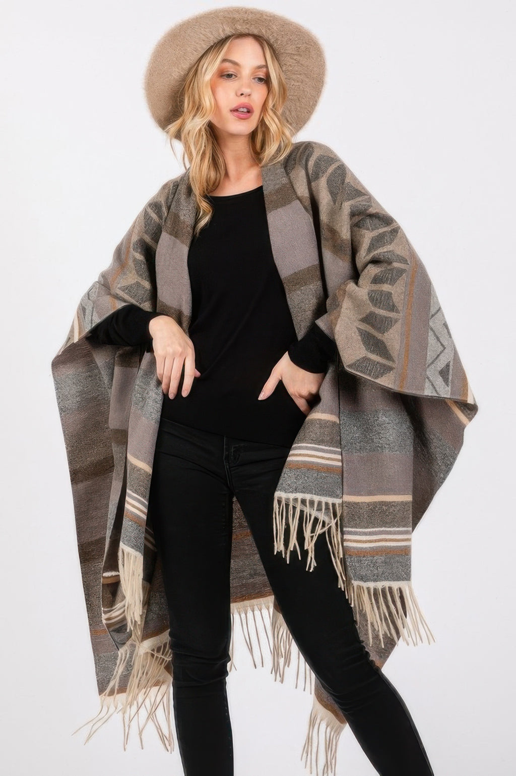Gray Aztec-pattern ruana draped with cream fringe hem over a black top
