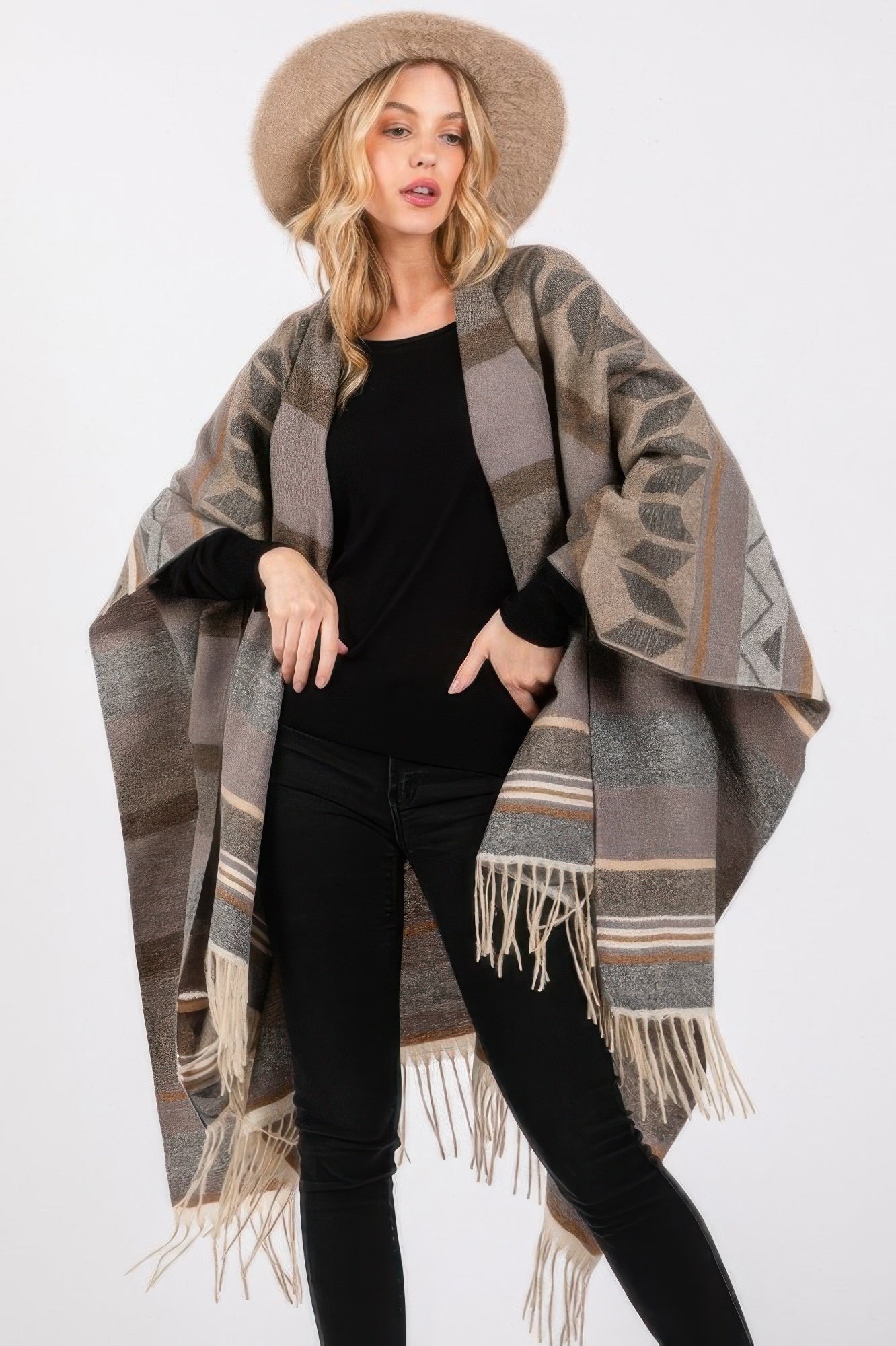Gray Aztec-pattern ruana draped with cream fringe hem over a black top