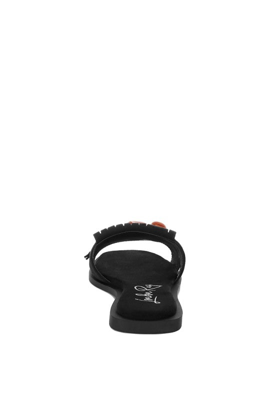 Black flat slip-on sandals with closed square toe and back sling strap
