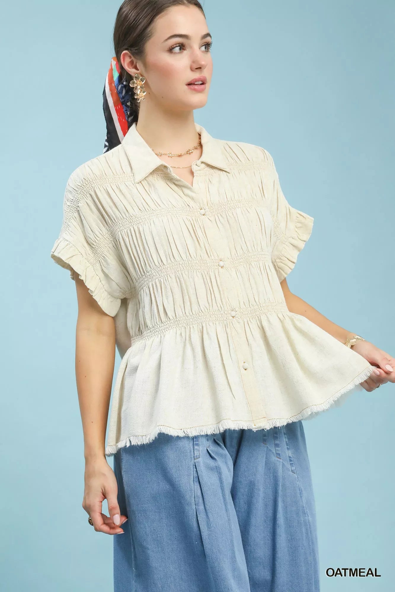 Oatmeal smocked yoke peplum-style button shirt with short ruffled sleeves