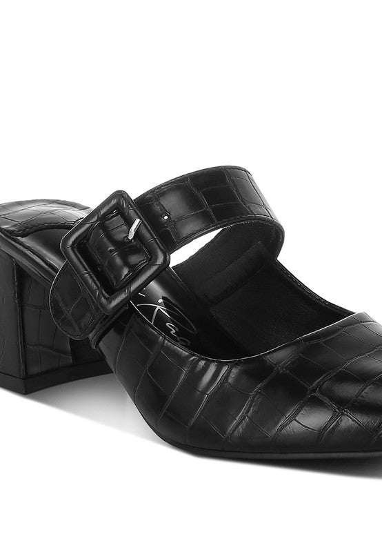 Black mule with croc upper and buckle sling strap, angled close-up