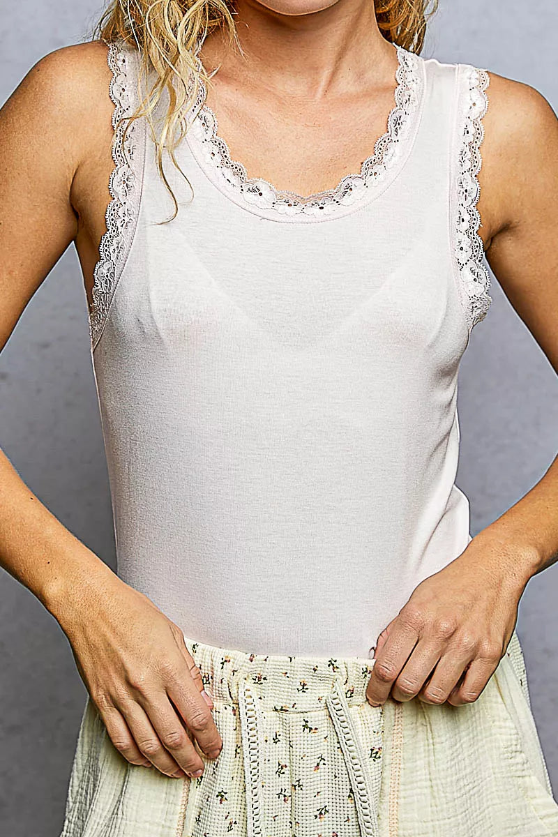 Blush cropped tank with lace-trimmed neckline, fitted bodice close-up