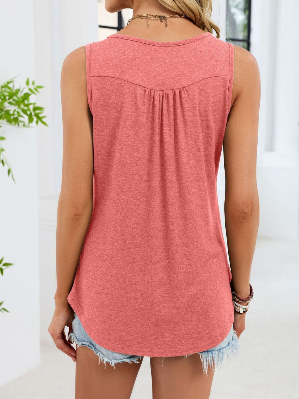 Pink sleeveless tank (back view) with yoke seam and relaxed straight hem