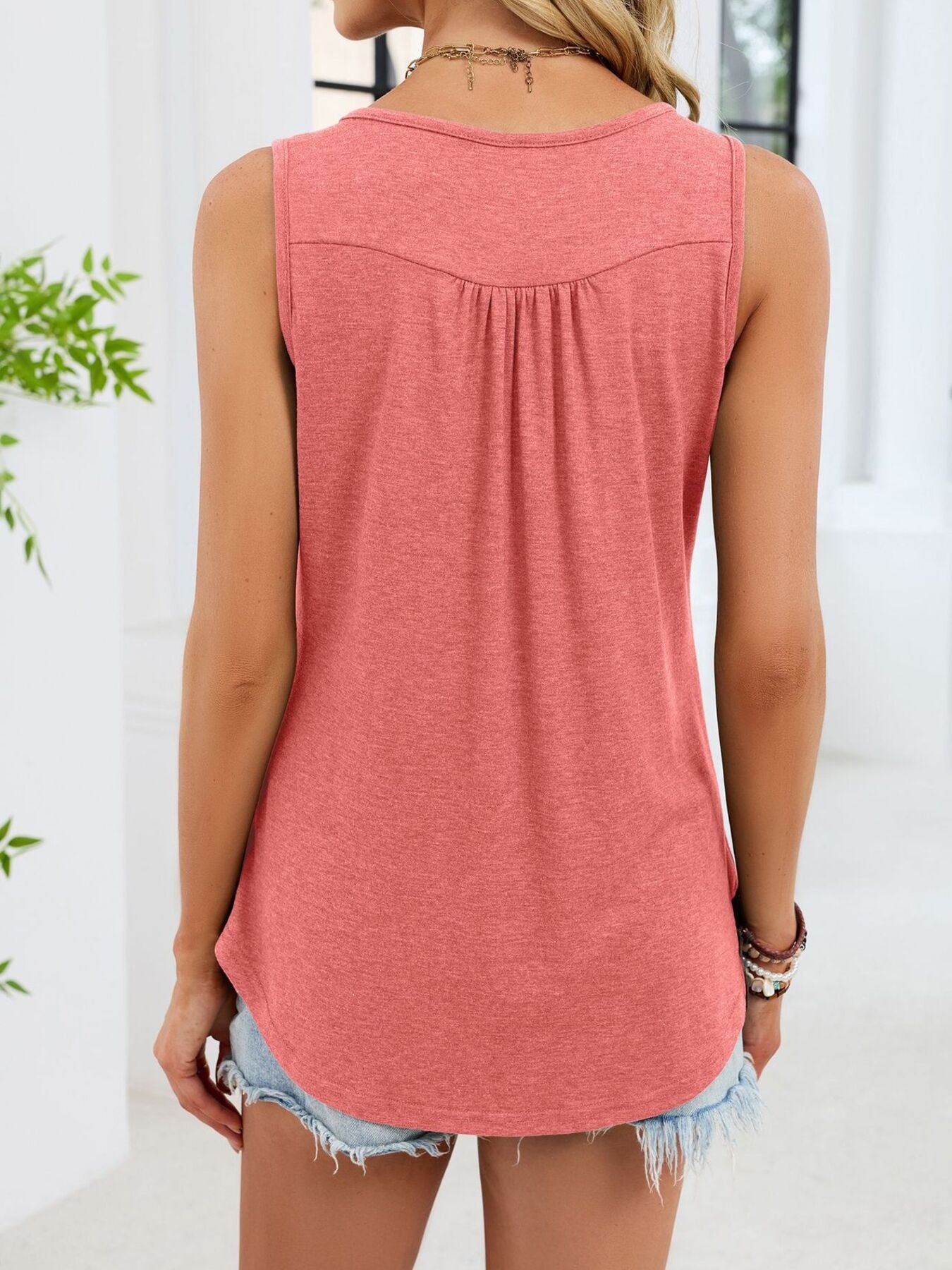 Pink sleeveless tank (back view) with yoke seam and relaxed straight hem