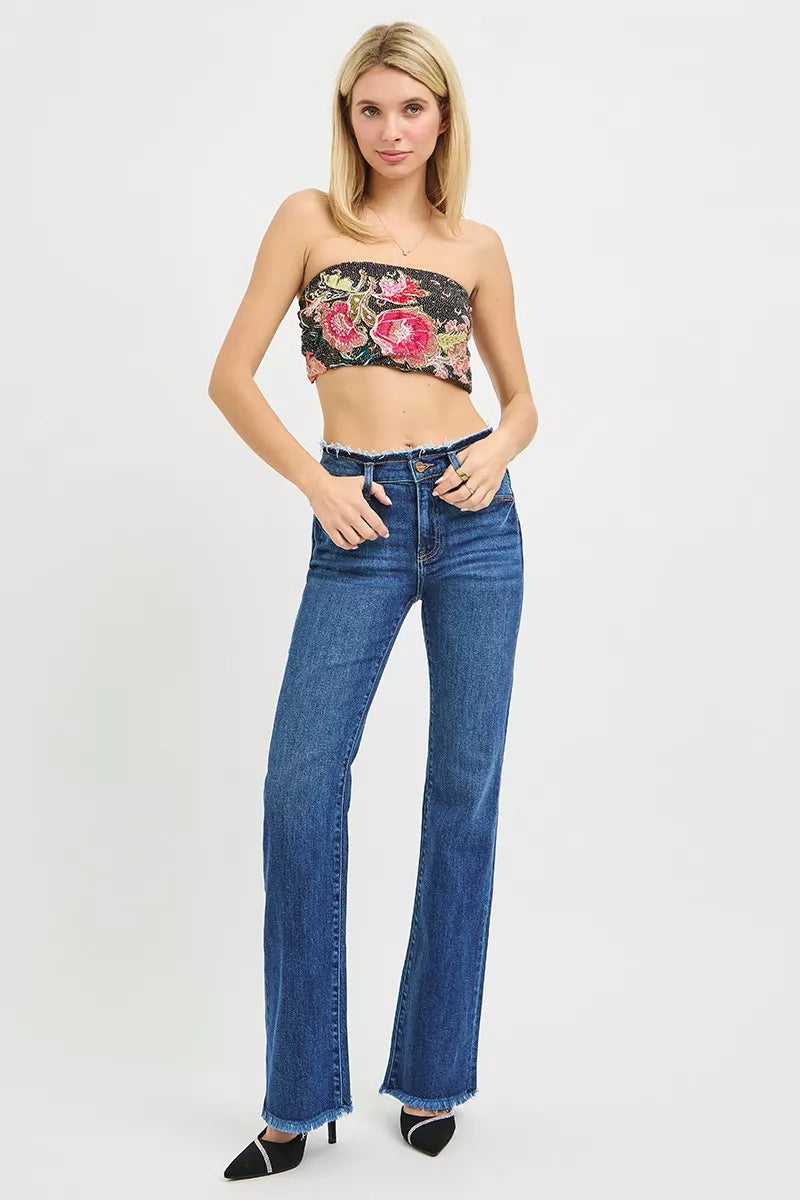 Mid-rise dark blue bootcut jeans with frayed hem and waistband detail