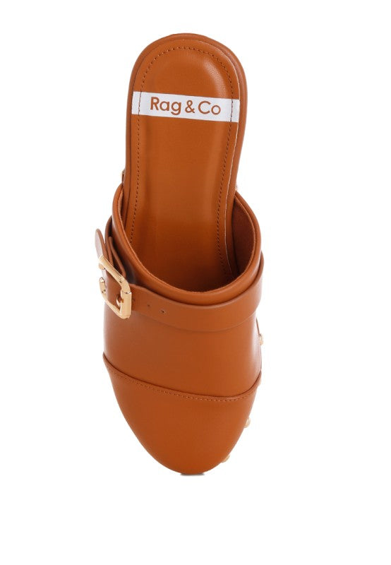 Tan leather clog with open top collar, buckle strap, and studded side trim