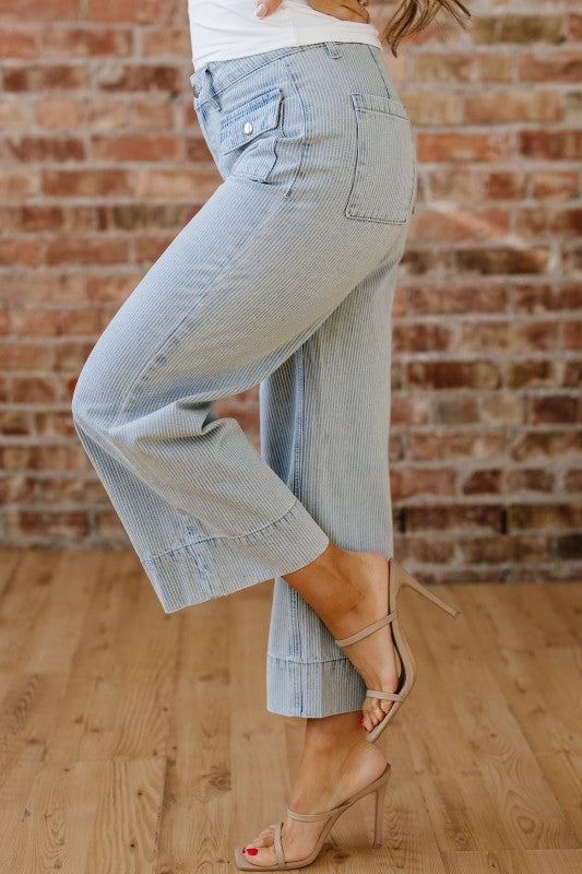Sky blue striped wide-leg jeans with side pockets, button fly, and stitched hem cuff