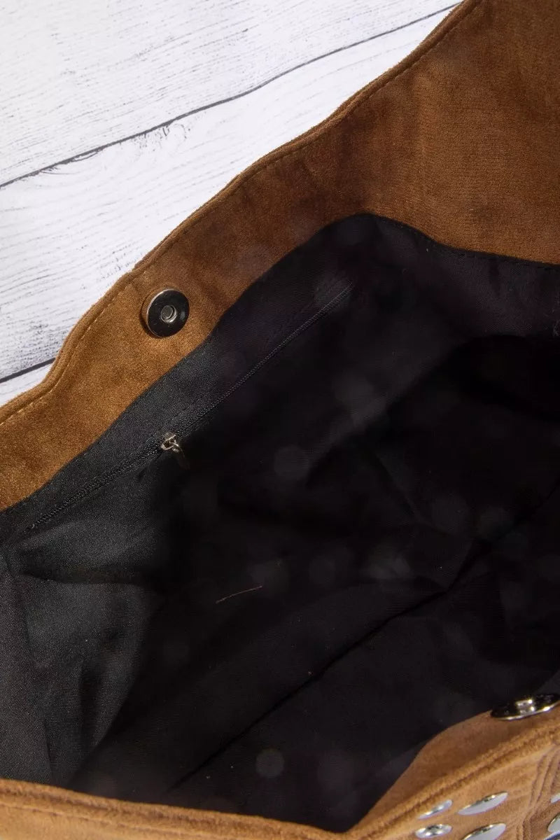 Inside view of the shoulder bag with dark lining and snap-button pocket