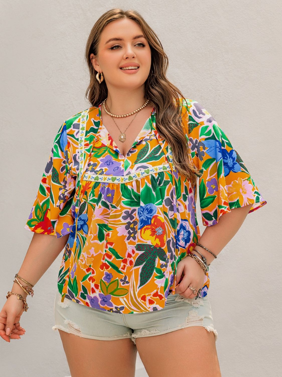 Plus Size Printed Tie Neck Half Sleeve Blouse - Tigbul's Variety Fashion Shop