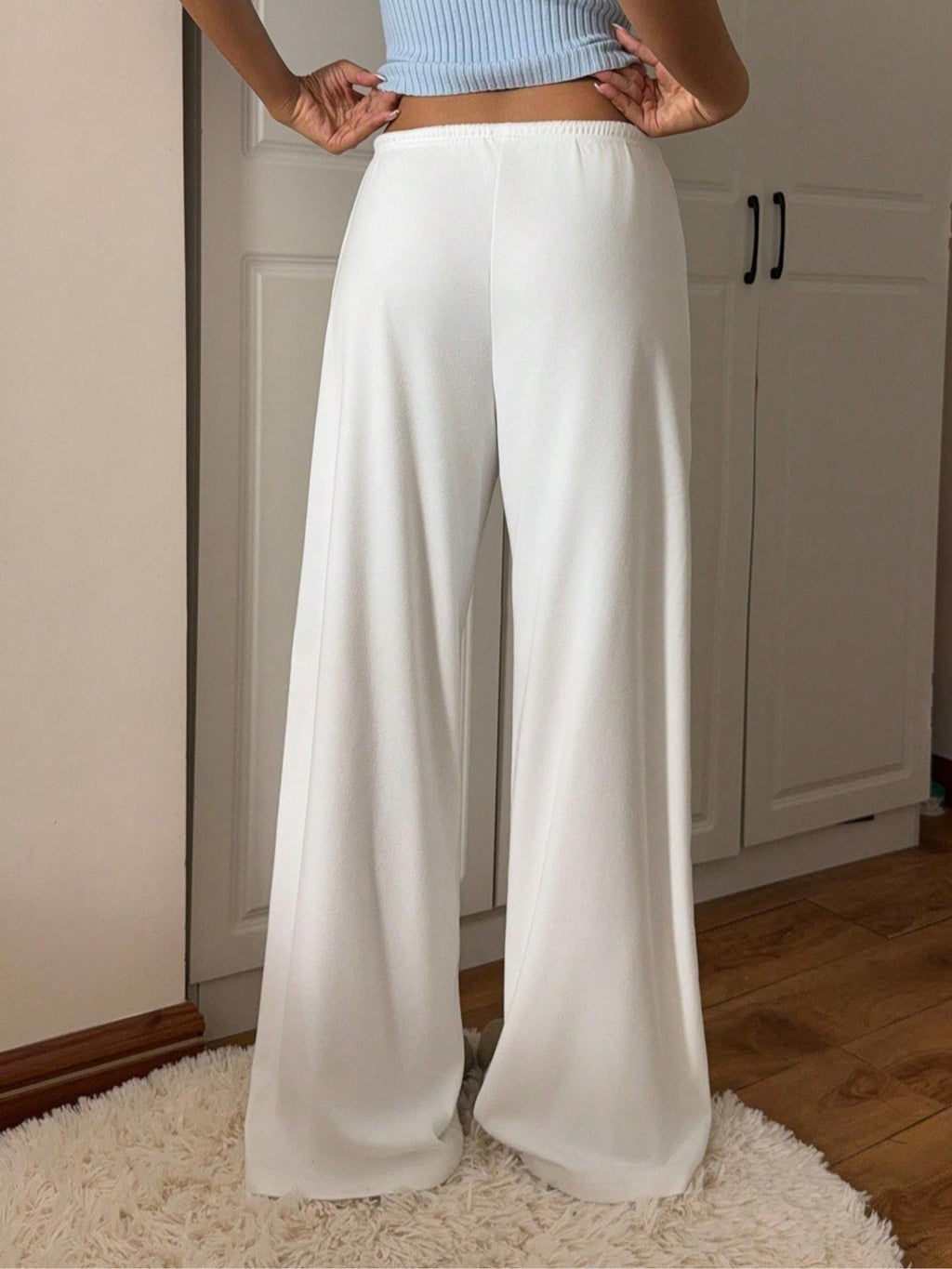 White relaxed fit drawstring pants with front tie and roomy straight-leg fit