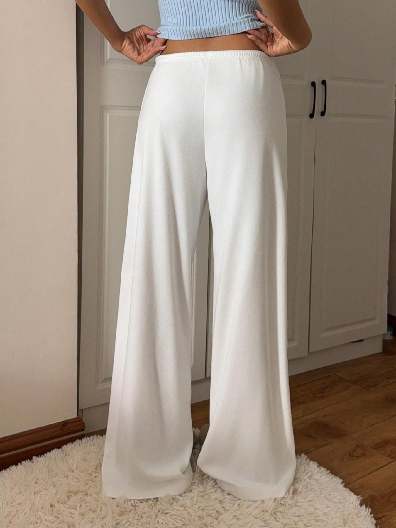 White relaxed fit drawstring pants with front tie and roomy straight-leg fit