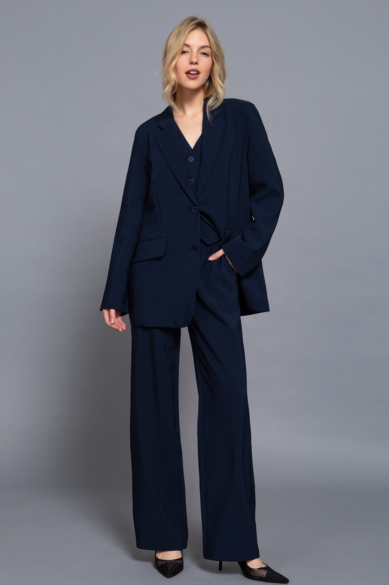 Navy long straight woven pants with elastic waist, front button, and belt loops