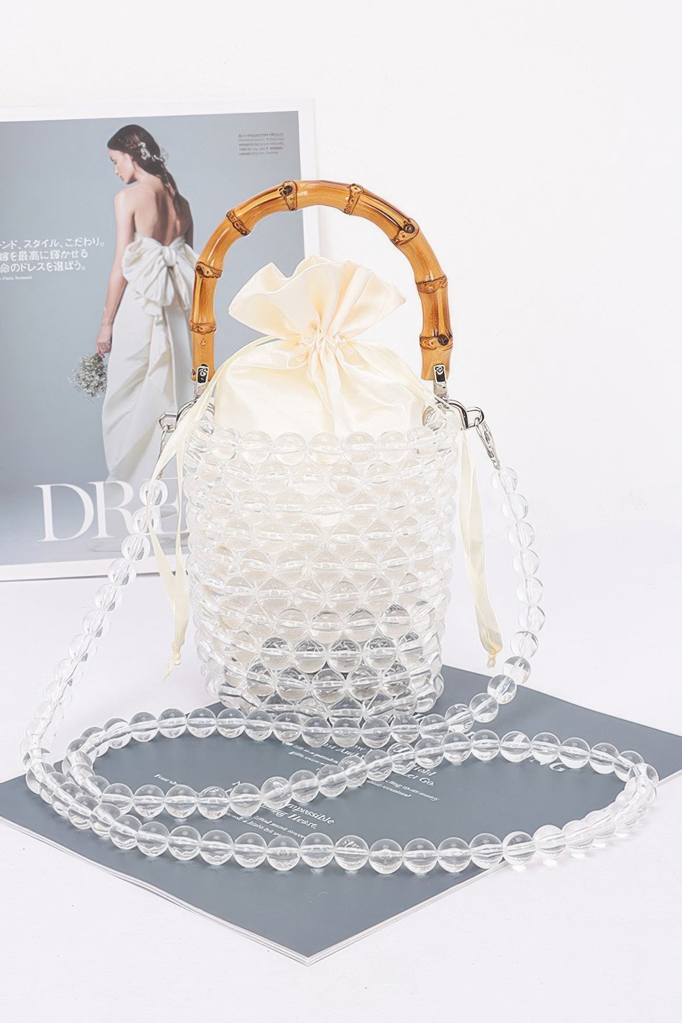 Clear beaded tote bag with bamboo handles and dangling beaded strap