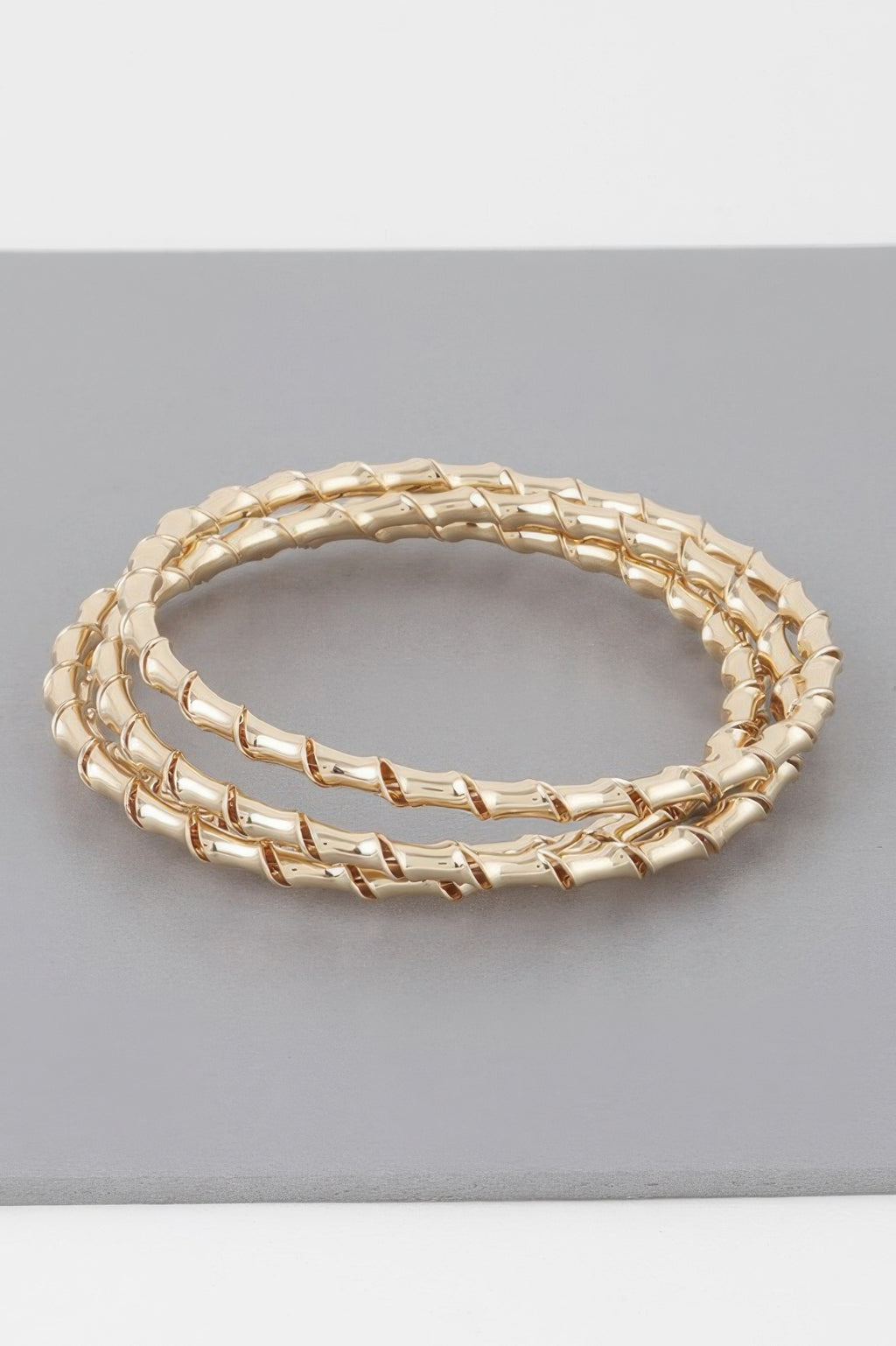 Gold bamboo twist bracelet, oval bangle with smooth twist links