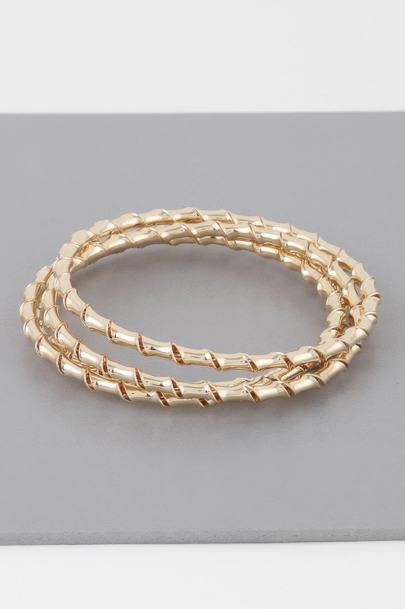 Gold bamboo twist bracelet, oval bangle with smooth twist links