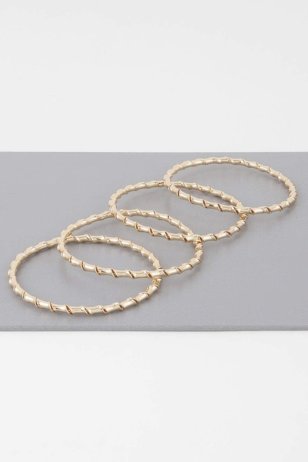 Gold bamboo twist bracelet set of three interlinked bangles, twisted chain links