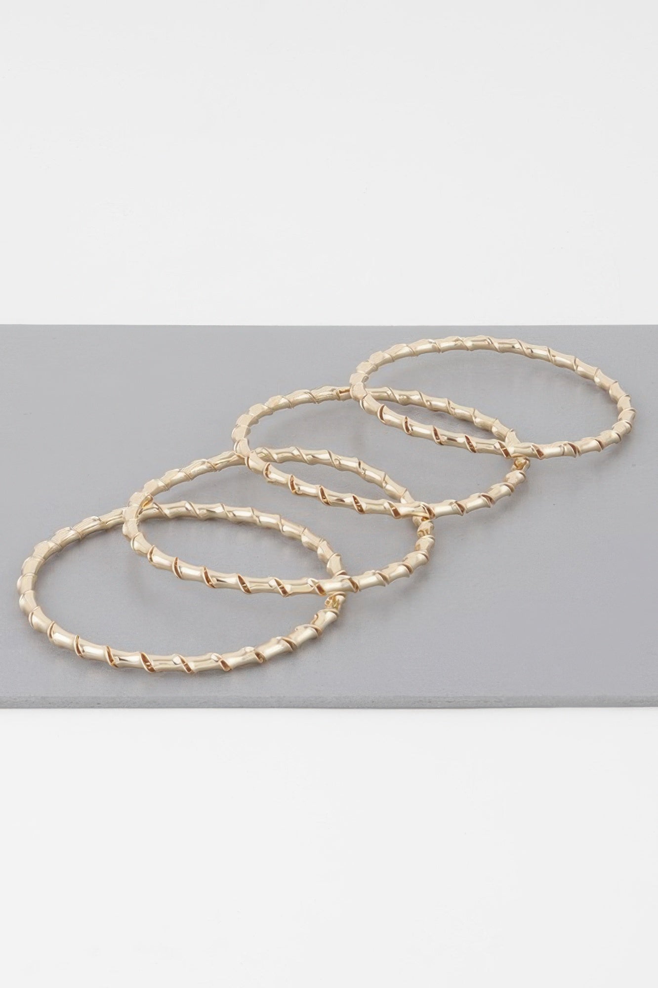 Gold bamboo twist bracelet set of three interlinked bangles, twisted chain links