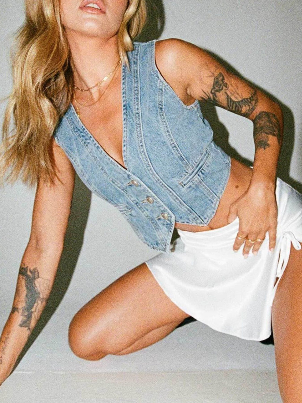 Light-wash denim V-neck button vest with angled seam detail