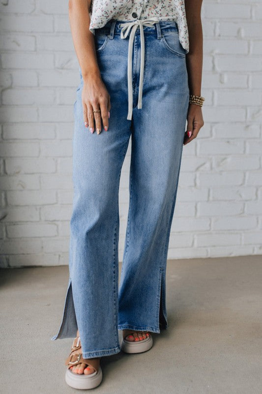 Light blue drawstring casual jeans, wide-leg fit with adjustable waist tie.