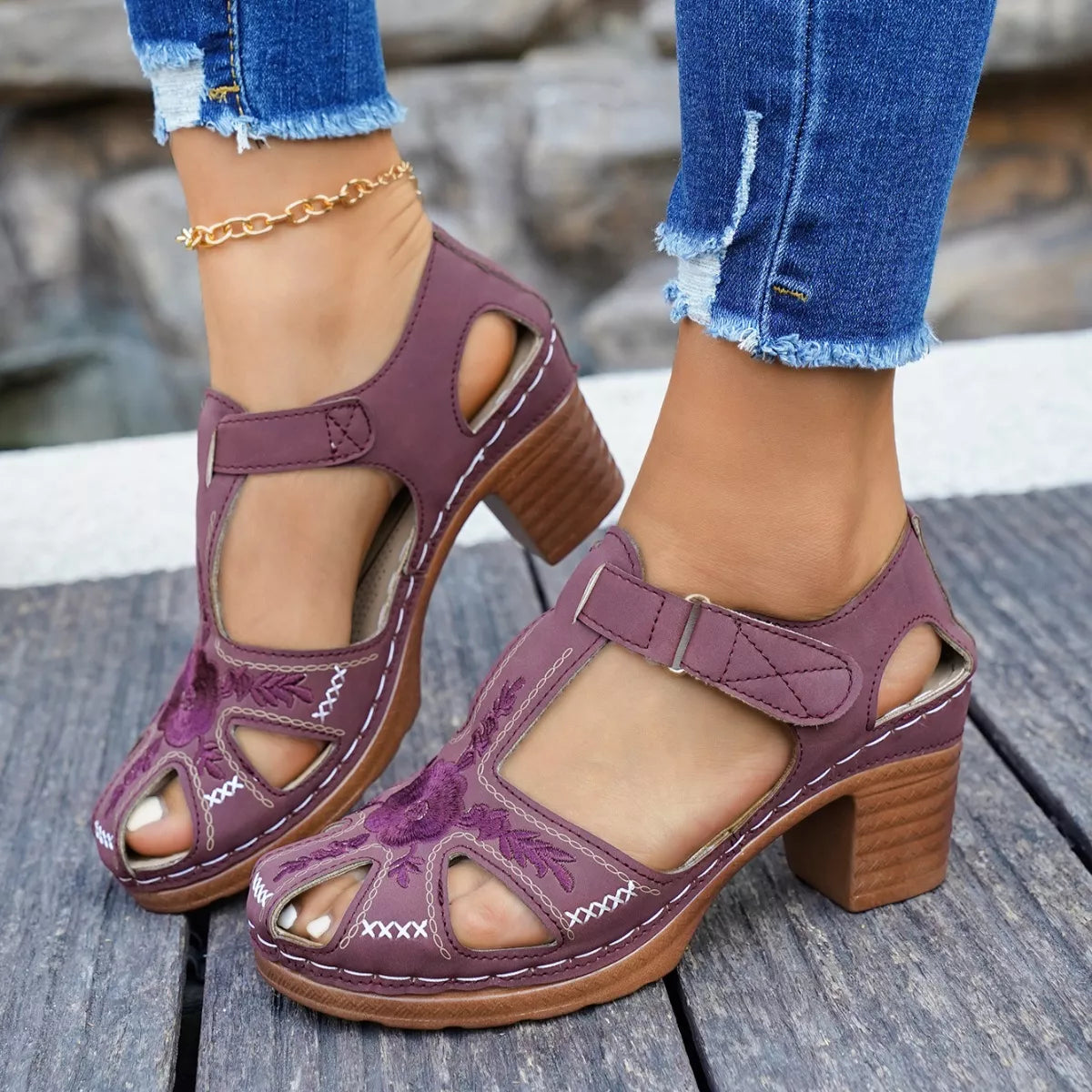 Purple cutout block heel sandals with wide ankle strap and decorative cutout panels