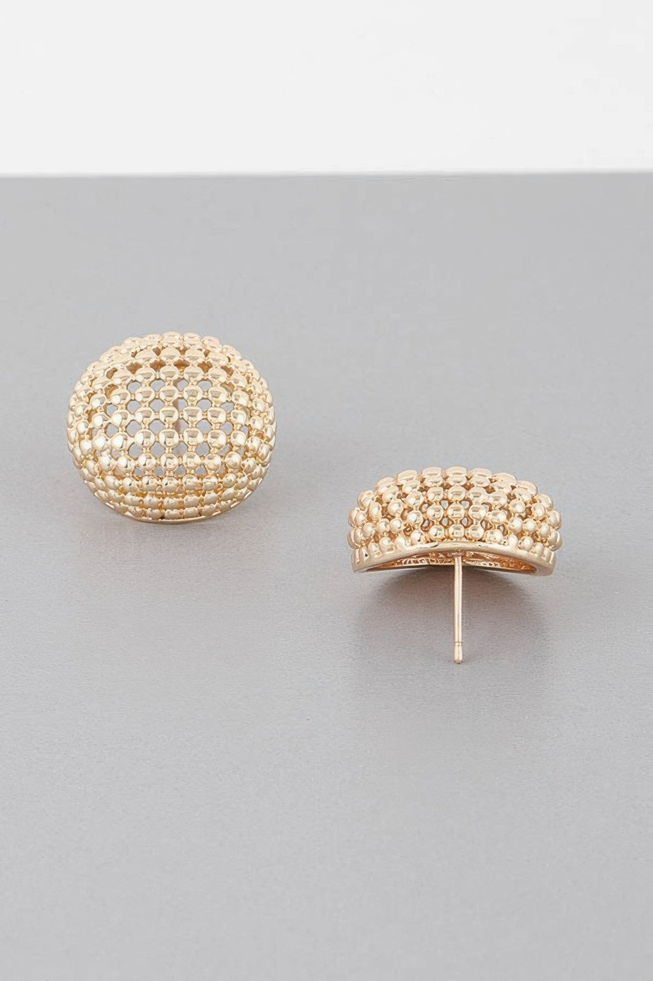 Gold tone beaded dome stud earrings, one earring shown with visible post back