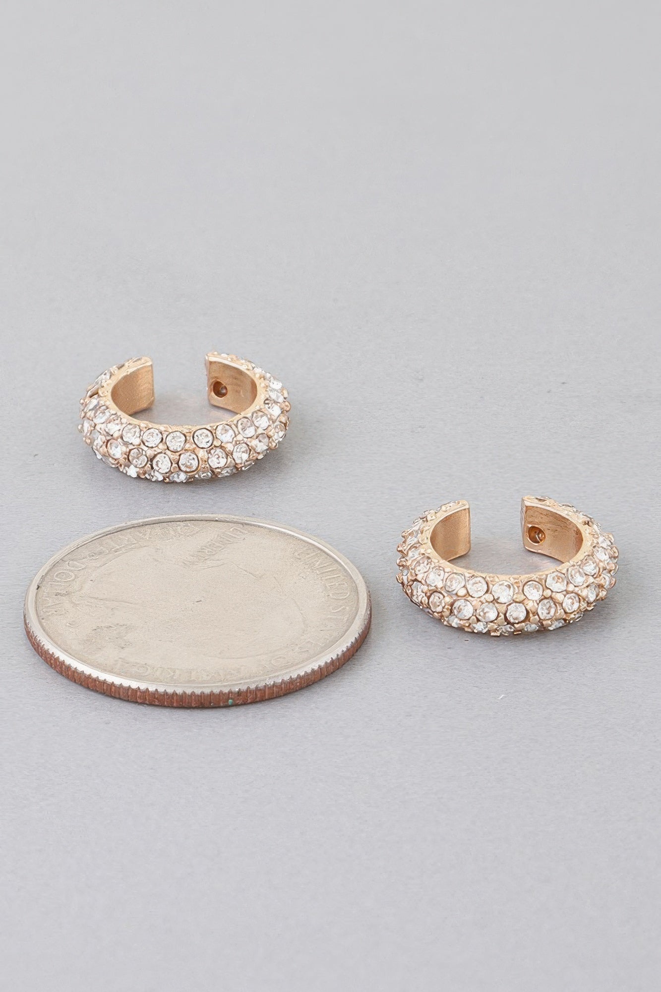 Gold-tone ear cuff with clear crystal stones, open-back half hoop