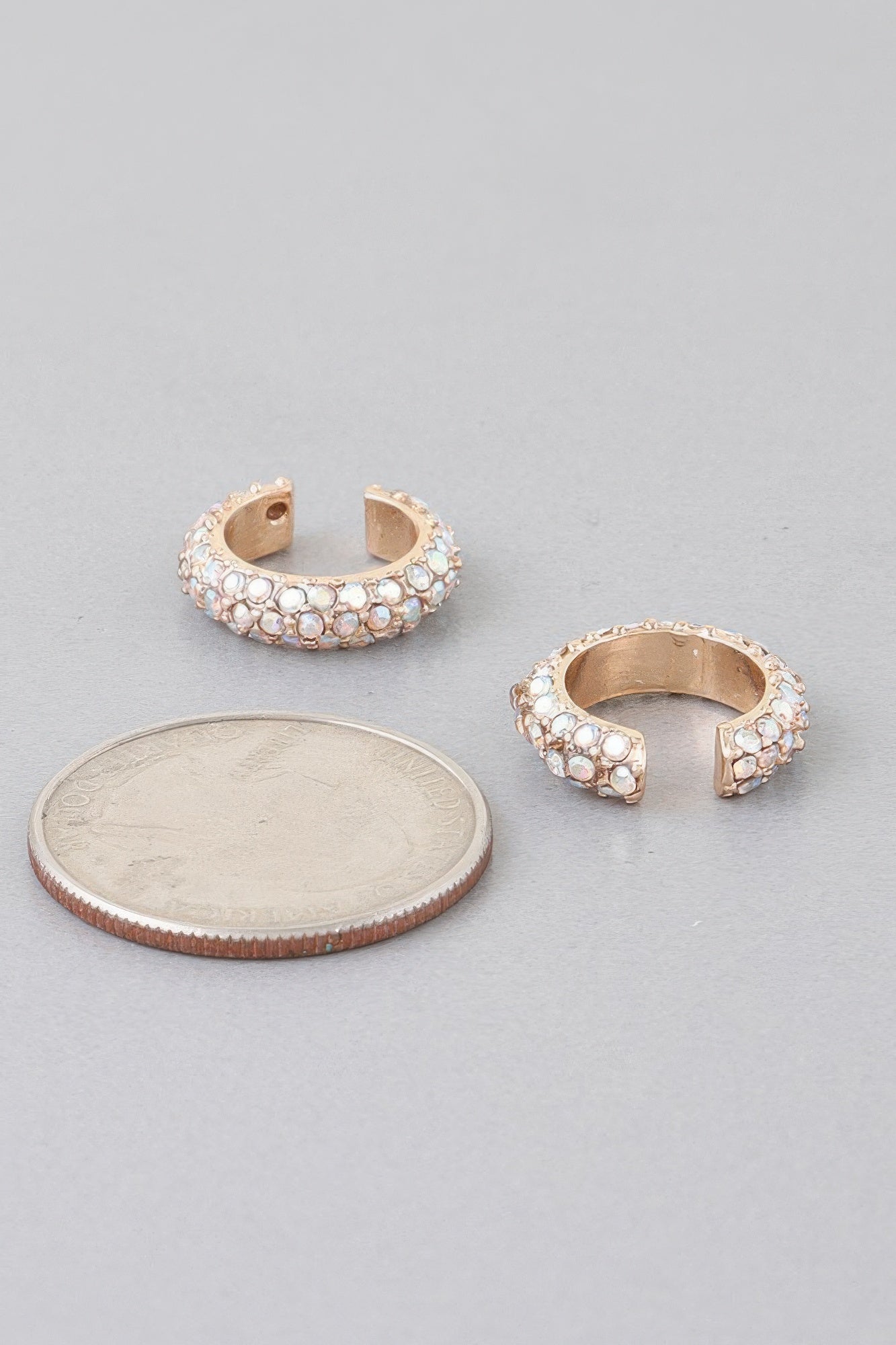 Gold-tone ear cuff with clear stones, curved open band and snap-back posts