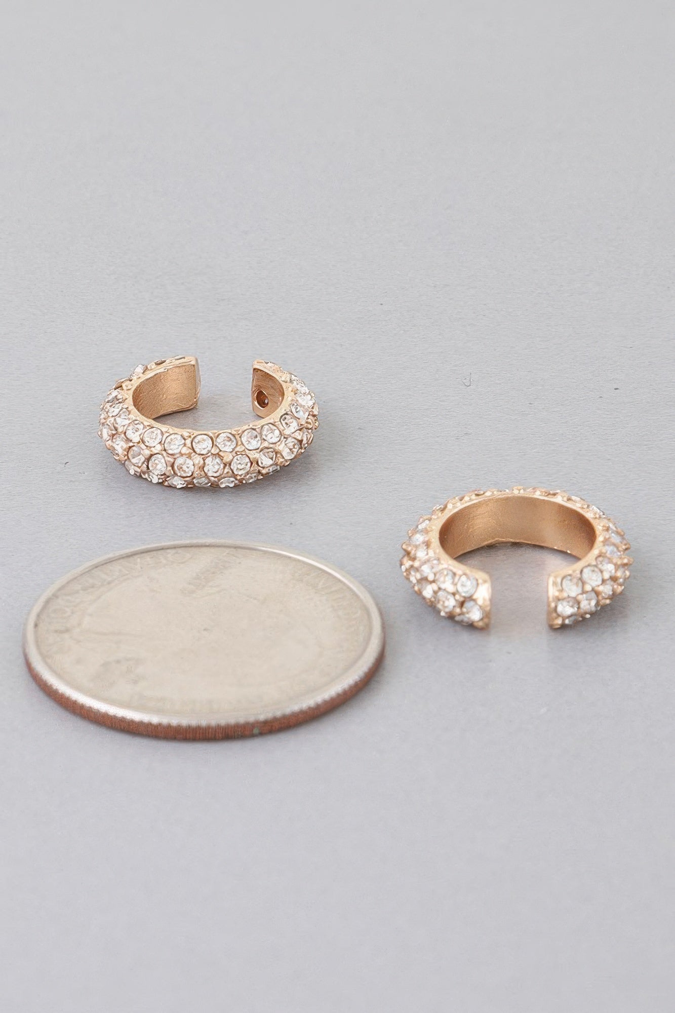 Gold-tone ear cuff earring with clear crystals and open back