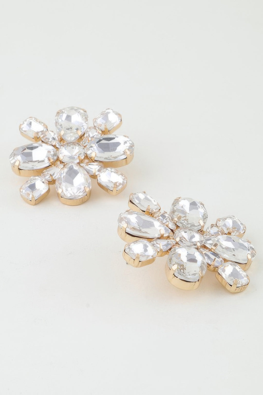 Clear rhinestone flower stud earrings, round and teardrop gems with gold-tone posts