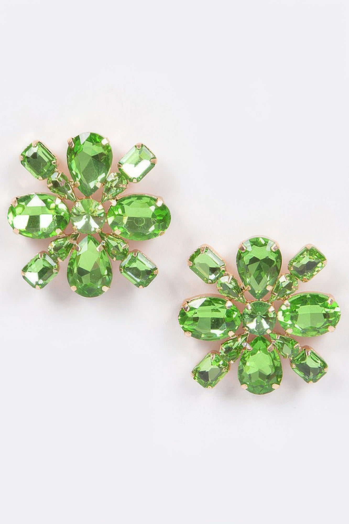 Green crystal flower stud earrings with gold-tone prong settings and faceted stones