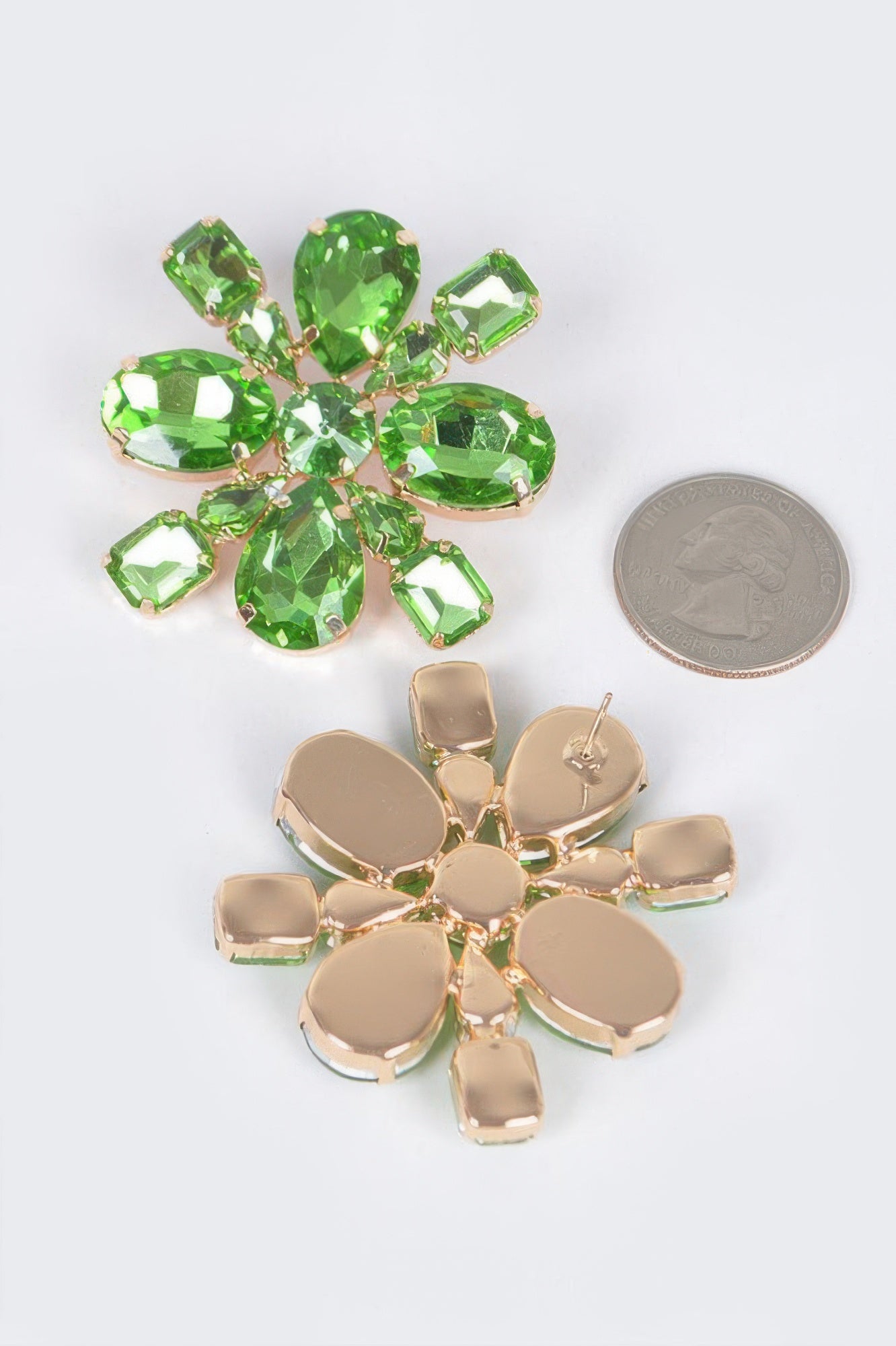 Green crystal flower stud earrings with gold-tone backs and faceted leaf-shaped stones