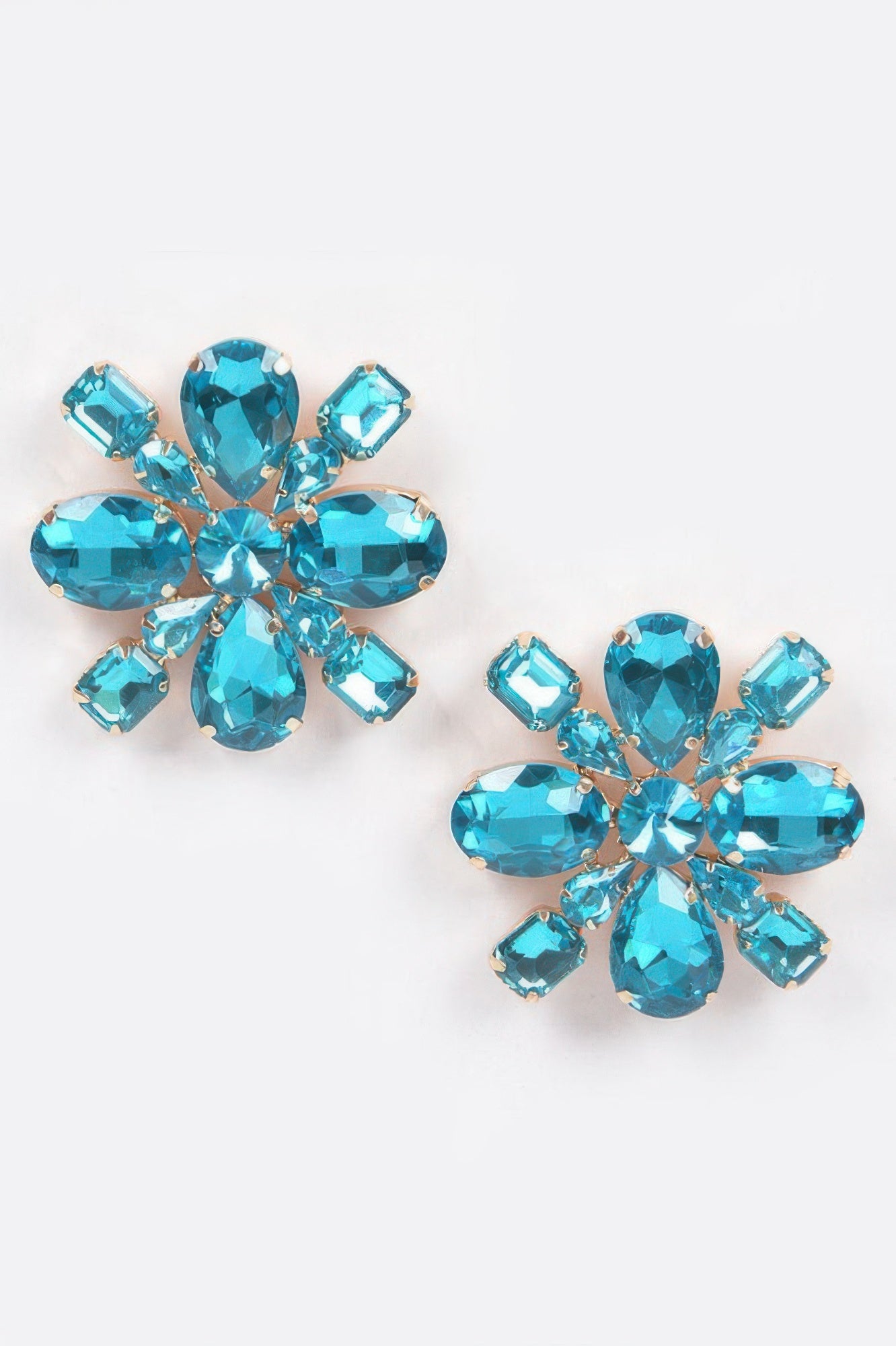 Blue crystal flower stud earrings with gold-tone prongs and faceted teardrop gems