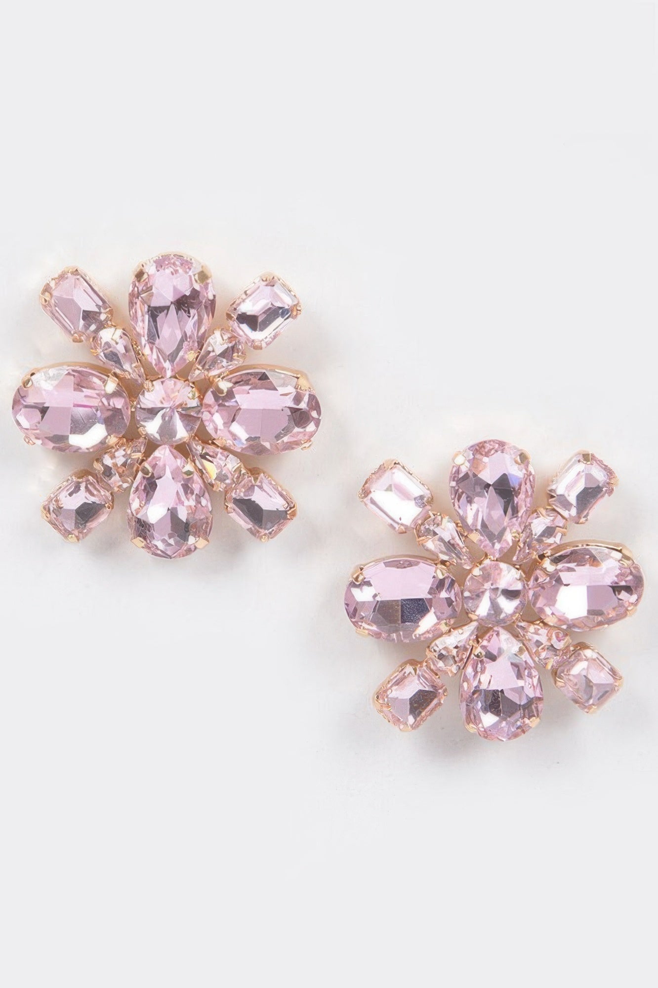 Pink crystal flower stud earrings with gold-tone prong settings and faceted stones
