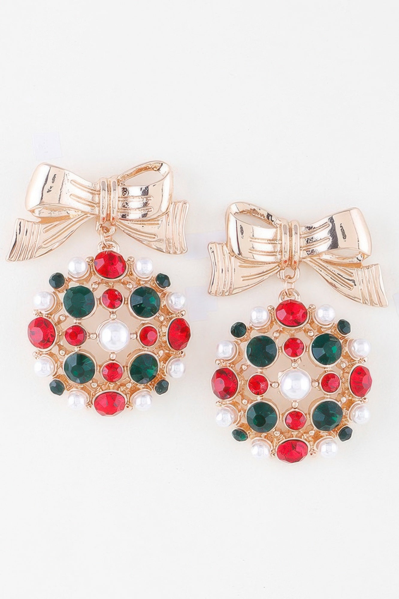 Bejeweled ribbon ornament earrings in gold with red, green and white pearl details