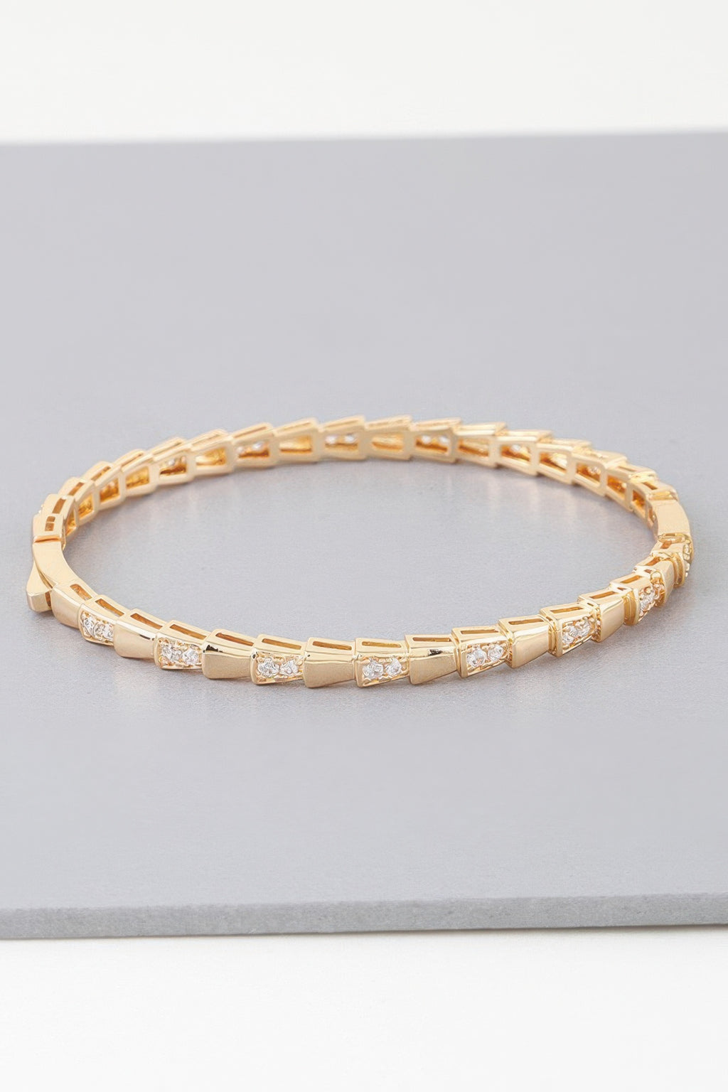 Gold snake-scale bracelet with rectangular links and small clear crystal accents