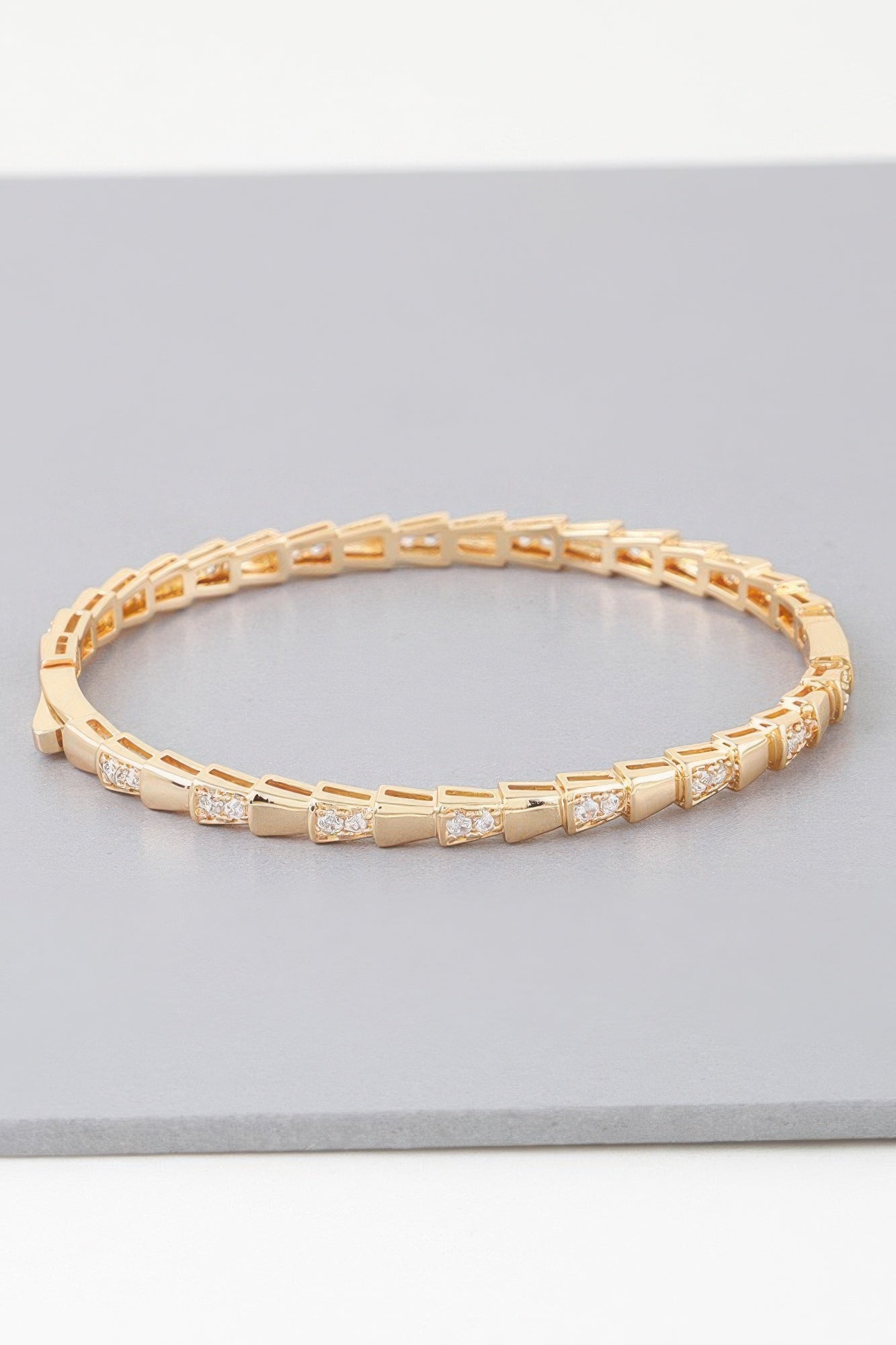Gold snake-scale bracelet with rectangular links and small clear crystal accents