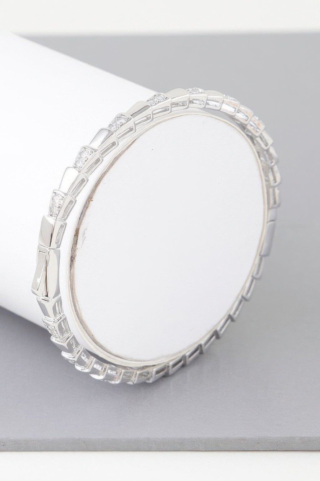 Silver snake-scale bracelet, hinged oval cuff with clear stone accents