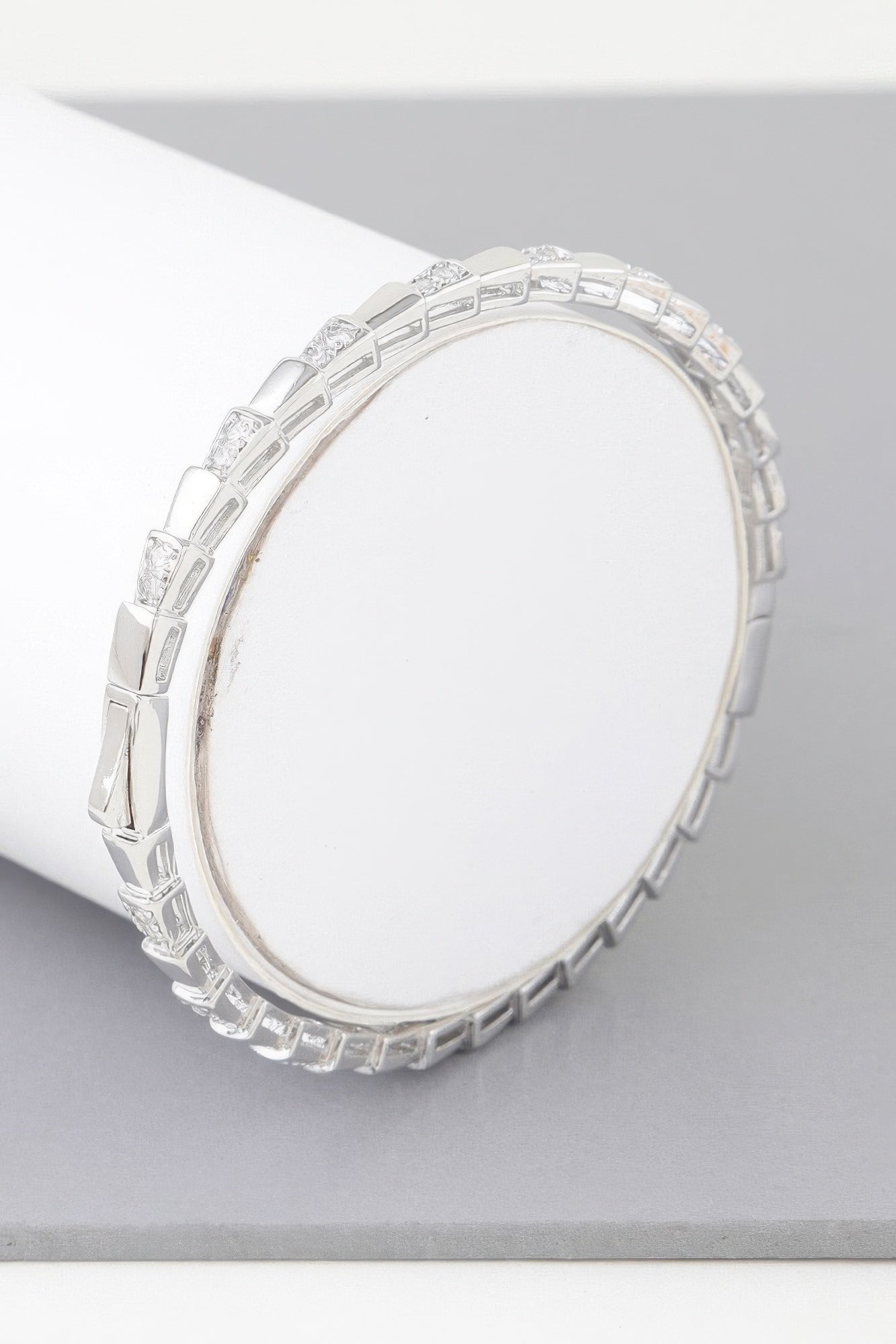 Silver snake-scale bracelet, hinged oval cuff with clear stone accents