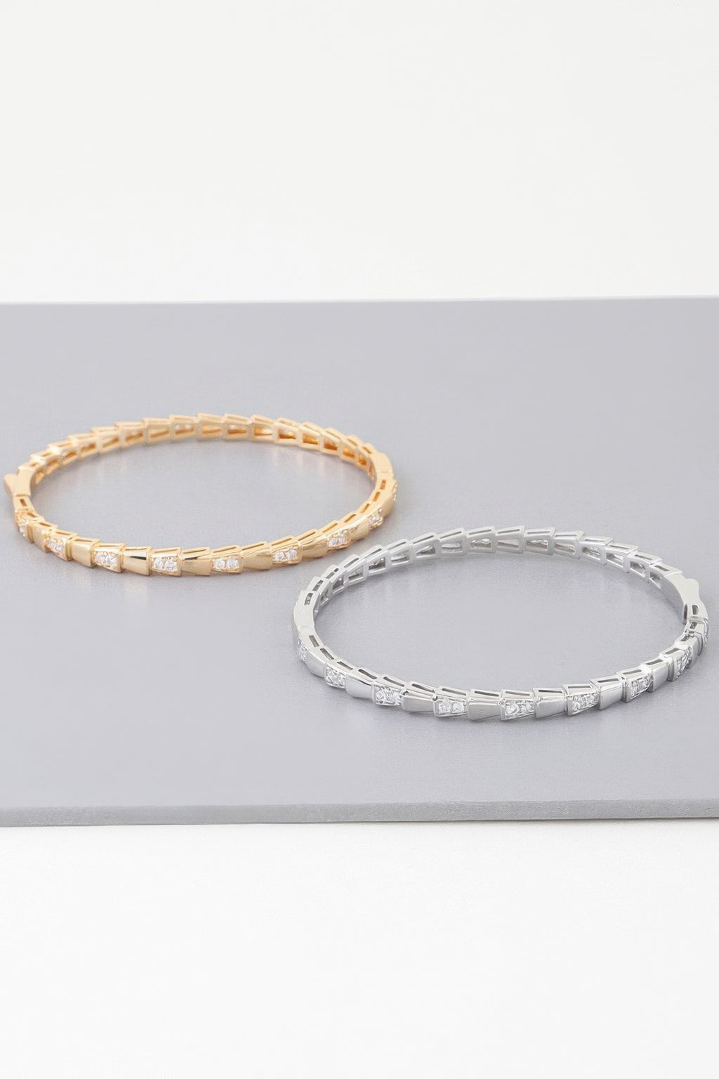 Gold and silver snake-scale bracelets with clear crystal-studded rectangular links
