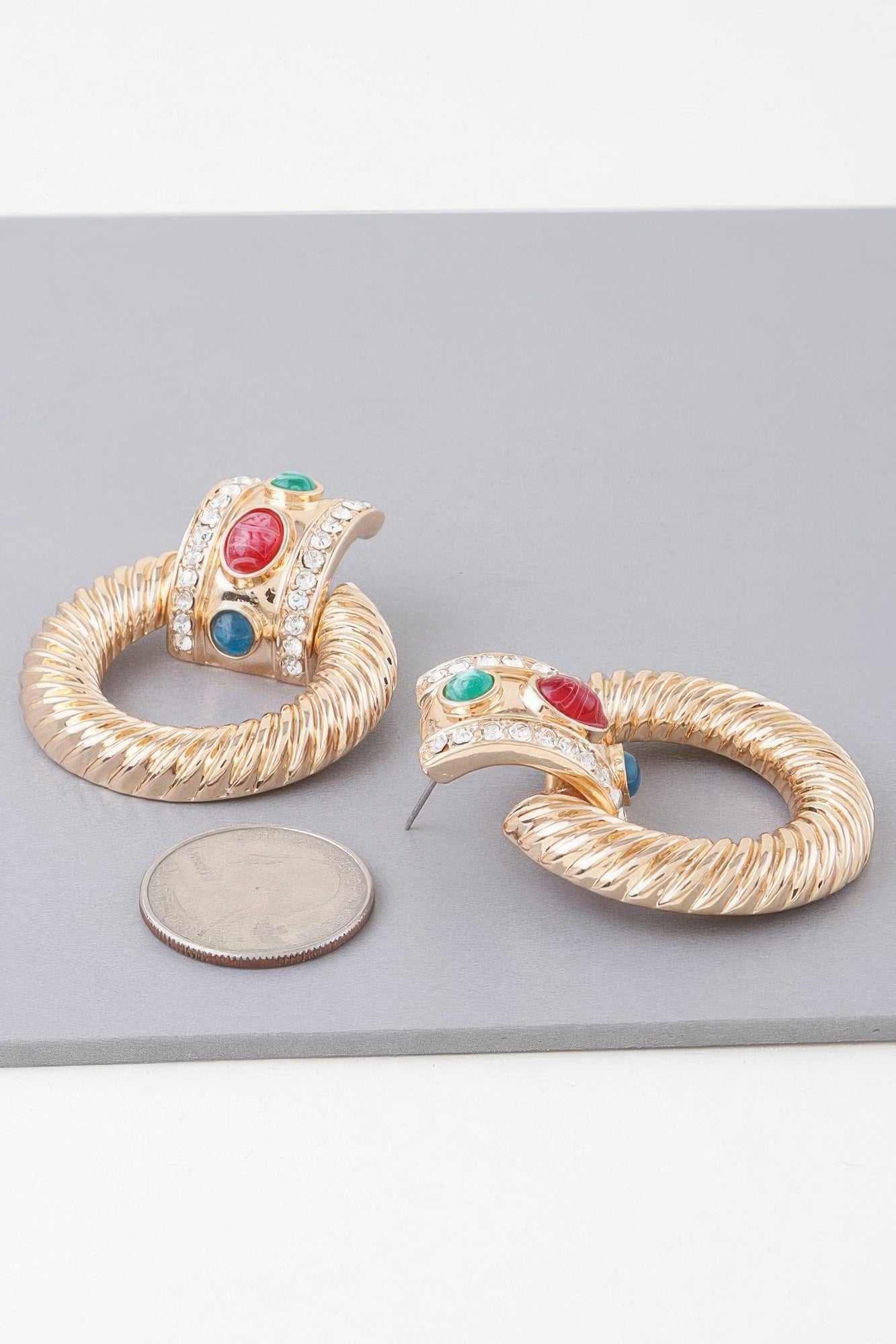 Bejeweled twisted hoop drop earrings, gold multicolor—pair view with red/blue/green stones